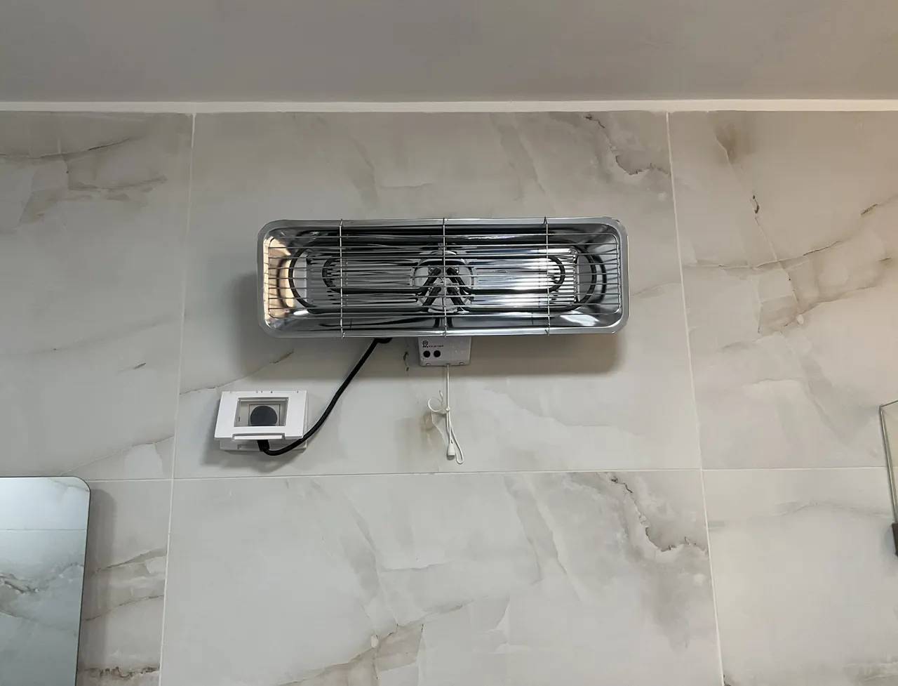 After: bathroom heater mounted on ceramic tiles and plugged in, drilled without cracking a tile