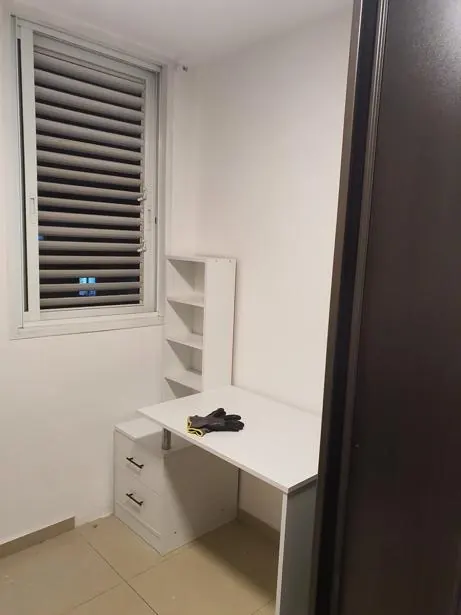After: white desk with drawers and a shelf unit assembled in a small home office